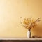 Wooden table with vase with bouquet of dried field flowers near empty, blank mustard wall. Home interior with copy space