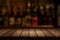 Wooden table with a view of blurred beverages bar