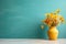 Wooden table with yellow vase with bouquet of field flowers near empty, blank turquoise wall. Home interior background