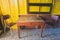 Wooden tables and classic wooden chairs are placed on yellow wooden walls