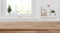 Wooden tabletop in front of blurred kitchen window, shelves background