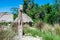 Wooden Taino idol and huts in village in Dominican Republic