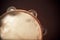 Wooden Tambourine on Brown Background