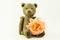 Wooden teddy bear with a rose