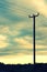 Wooden telegraph pole and the afternoon sky