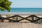 Wooden terrace with beach, ocean and blue sky background -