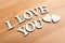 Wooden texture letters forming with phrase I Love You