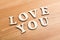Wooden texture letters forming with phrase Love You