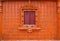 Wooden Thai window on brown tile wall