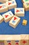 Wooden tiles in mahjong game on blue cloth table