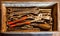 The wooden tool box of hand tools with old and dirty, rusty wrenches, ring spanners, pliers, screwdrivers, chisel and other