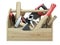 A wooden toolbox containing with ax, chisel, pliers, mallet, hammer, screwdriver, wrench, saw and wire cutters - front view