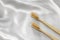 Wooden toothbrushes on silk fabric. Oral cavity care. Environmentally friendly personal hygiene products