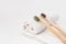 Wooden toothbrushes on white towel with copy space. Ecological material and dental care