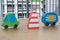 Wooden toy cars with traffic pylon on the table.