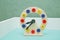 Wooden Toy clock for kid, on white . Wooden beautiful colorful clock dial clock-face on isolated white