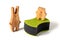 Wooden toy hare and bear and black sponges for washing dishes and other domestic or household needs. Concept of
