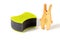 Wooden toy hare and two black sponges for washing dishes and other domestic or household needs. Concept of involving