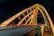 Wooden traffic bridge in the evening with illuminated curved lines and high-up perspective