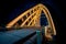 Wooden traffic bridge in the evening with illuminated curved lines and high-up perspective