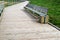 Wooden trail with bench and garbage bin