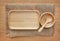 Wooden tray, bowl and spoon on sack against wood board background