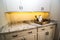 Wooden Tray With Bowls & Pitcher On Granite Kitchen Counter