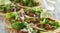 Wooden tray with carne asada tacos on corn tortilla