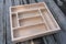 Wooden tray, cutlery organizer on a gray background