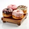 A wooden tray holding three different flavored donuts