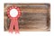 Wooden tray with round ribbon seal or badge, isolated