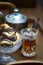Wooden tray with a teapot and a crystal glass with tea