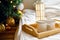 Wooden tray and two white mugs on bed on white sheet