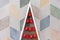 Wooden triangular Christmas tree in style modern with red Christmas balls