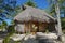 Wooden tropical bungalow with thatched roof