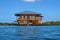 Wooden tropical home over water of Caribbean sea