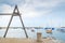 A wooden tuna hoist overlooking sailboats in Rockport harbor