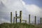 A Wooden turnstile in the english countryside with blue sky and fluffy clouds behind