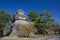 wooden turret or yagura on stone wall of Kumamoto castle in Japan with green tree