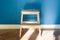 Wooden two step ladder stool with blue matte wall background