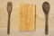 Wooden utensils and cutting board on wooden background