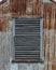Wooden Vent on Rusted Building Vertical