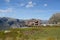 Wooden viewpoint atop a hill surrounded by rocky mountains in Norway.