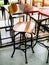 Wooden vintage bar stool with black steel legs in cafe