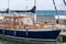 Wooden vintage blue yacht stands near the pier