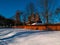 Wooden vintage country house in mountains forest covered snow on nature landscape. Active rest. Snowy winter holidays