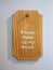 Wooden vintage door sign hanger with wording PLEASE MAKE UP MY ROOM hanging on the wall