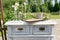 Wooden vintage Dresser, with flower decoration in garden. outdoor. selective focus