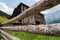 Wooden vintage fence on the background of an old wooden barn in a mountain Caucasian village