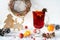 Wooden vintage rustic christmas decoration and hot mulled spiced red wine in glass mug Interior eco decor.